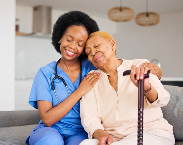A smiling caregiver conversing with an elderly resident in a home environment